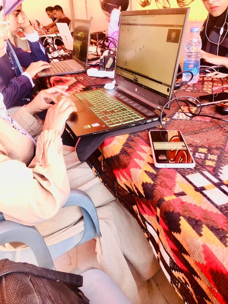 Female students working at laptops at Riva Hub